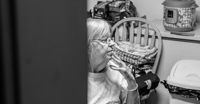 Woman in her kitchen looking concerned