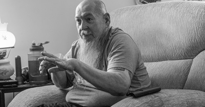 Man sitting in chair talking